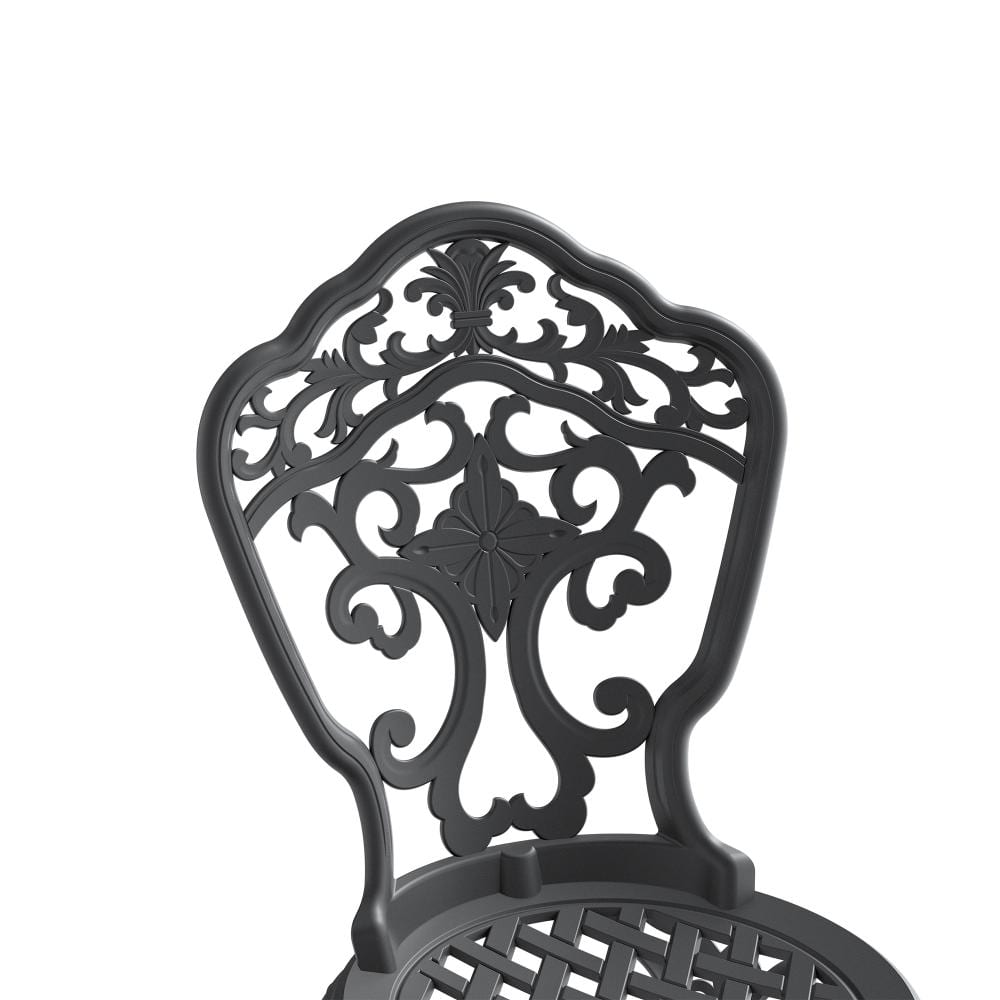 Close-up of the ornate backrest of a black metal chair.