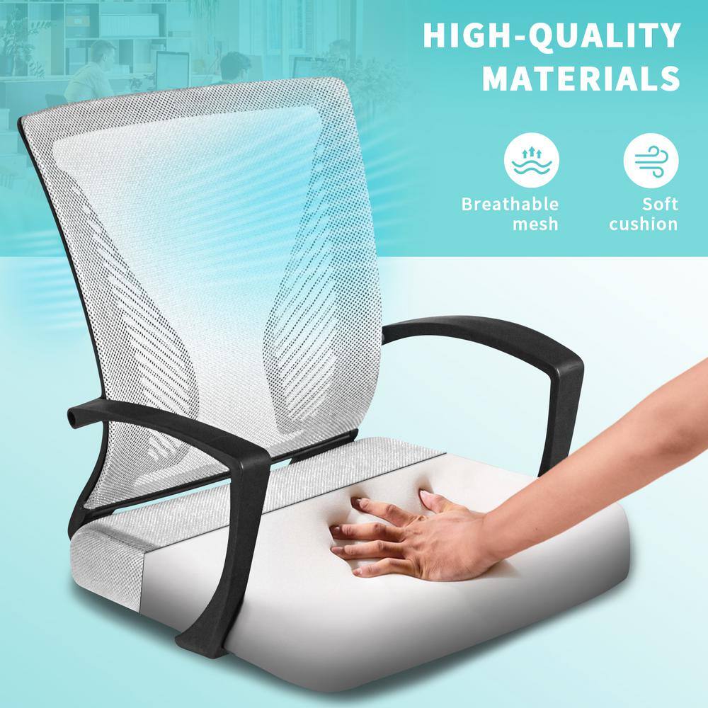 Close-up of a person's hand touching the soft white cushion of an ergonomic mesh chair.