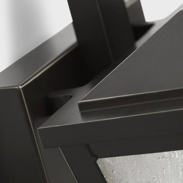 SCOTT LIVING - Kennewick 6.5 in. W x 10 in. H 1-Light Antique Bronze Outdoor Wall Lantern with Distressed Seeded Glass Shade