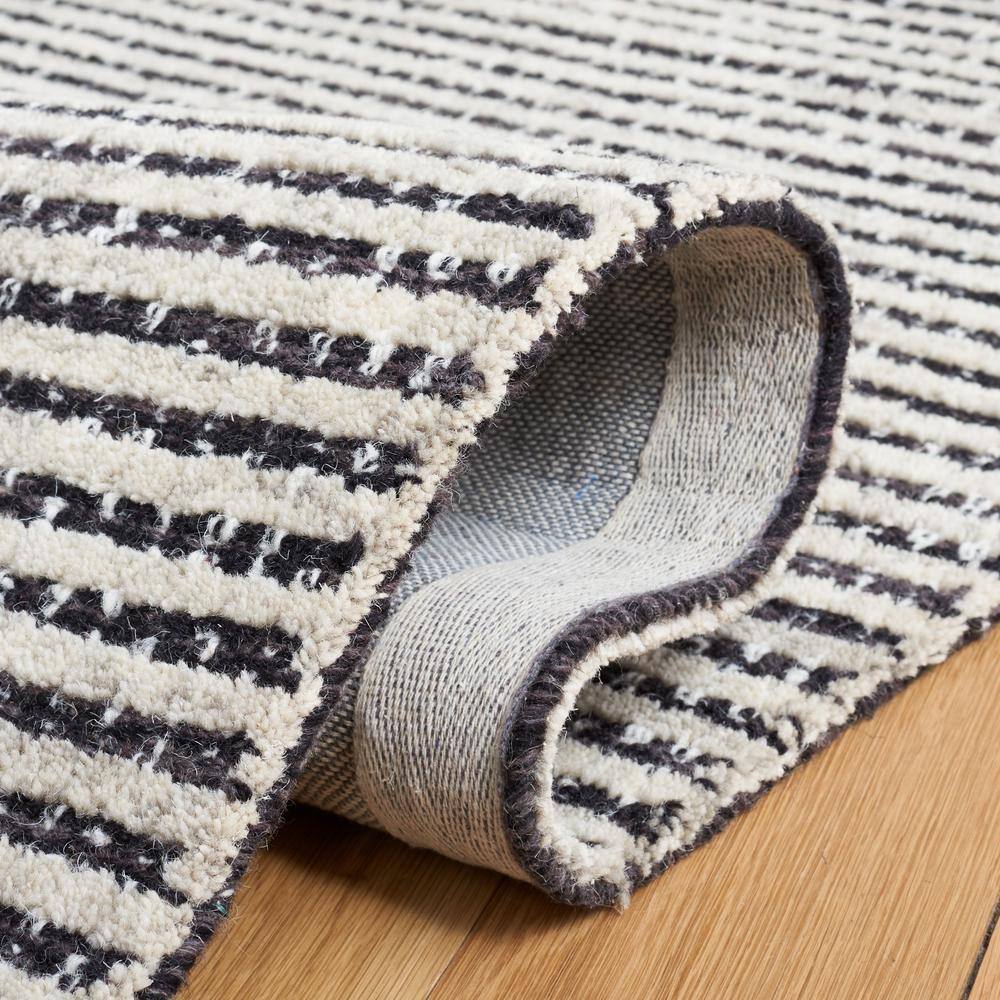 Handmade Black and Ivory Abstract Wool Area Rug, 5' x 8'