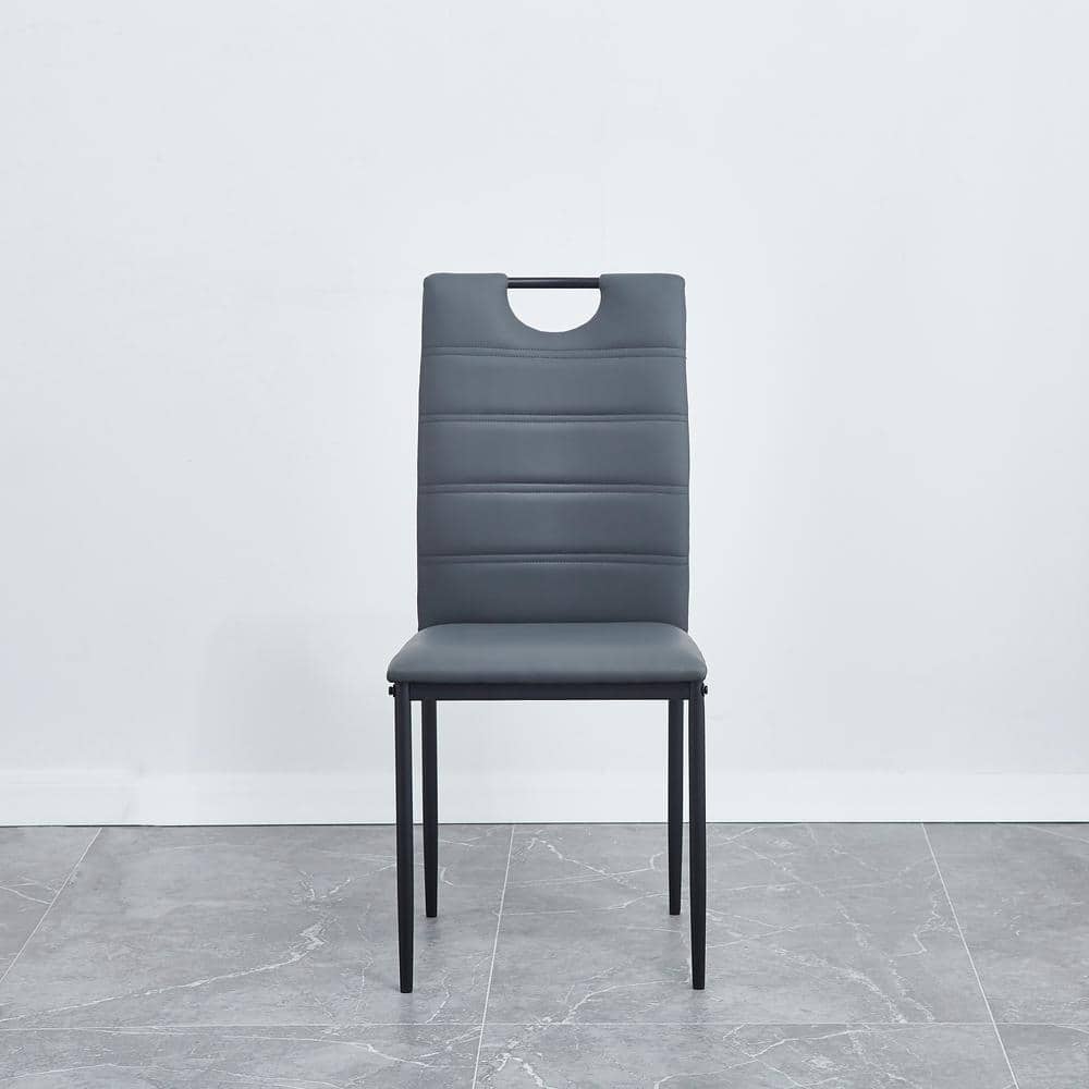 A set of 4 leather dining chairs with cushion and high back