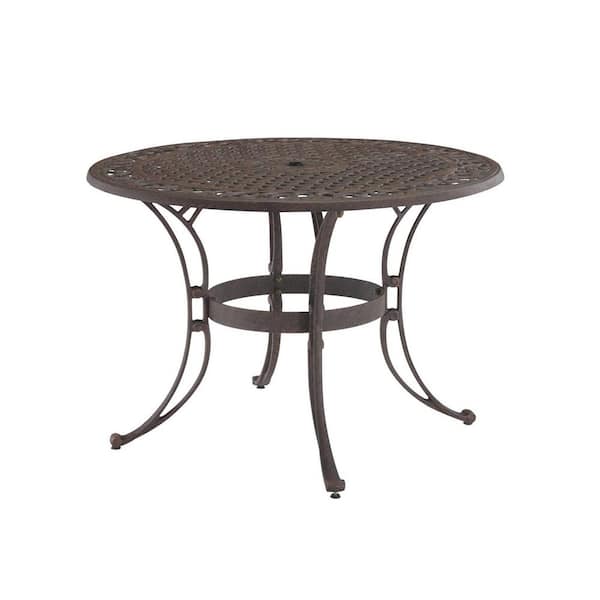 HOMESTYLES Sanibel Rust Bronze 7-Piece Cast Aluminium Round Outdoor Dining Set with Coral Cushions and Umbrella