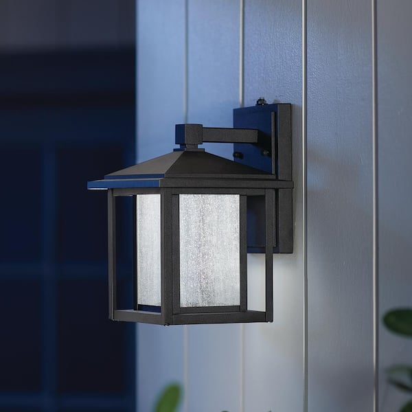 Home Decorators Collection Mauvo Canyon 11 in. Black Dusk to Dawn Small LED Outdoor Wall Light Fixture Porch Sconce with Seeded Glass