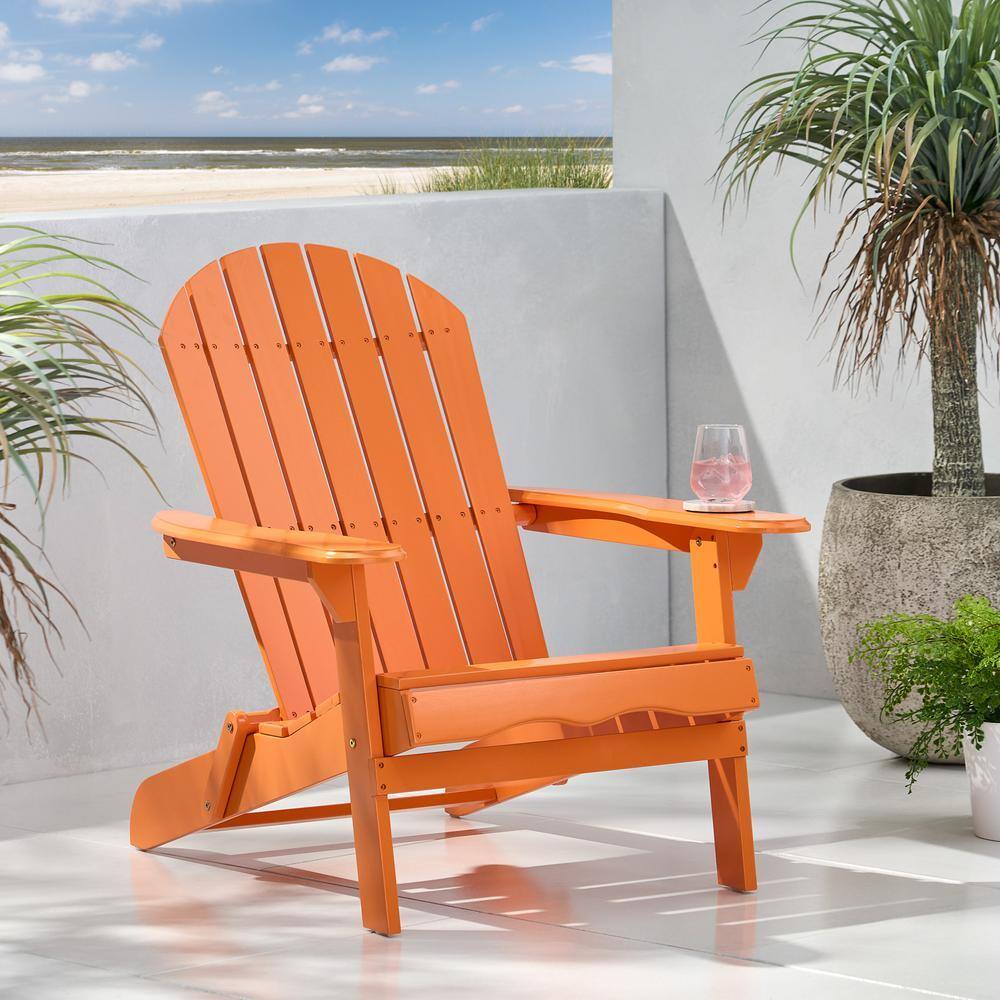 Tangerine orange Adirondack chair on a bright outdoor patio.