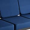 Close-up of the navy blue cushions and frame of the sofa.