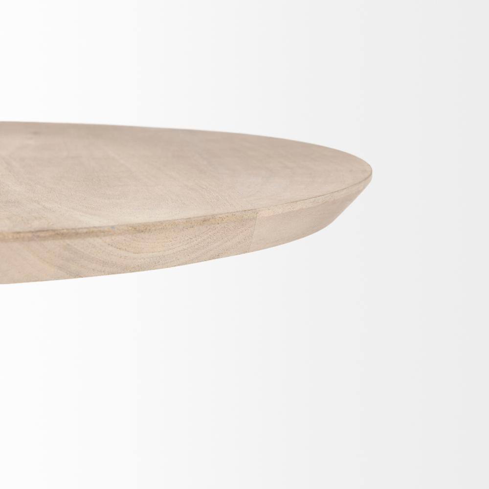 Close-up of the edge of a round light brown wood table top.