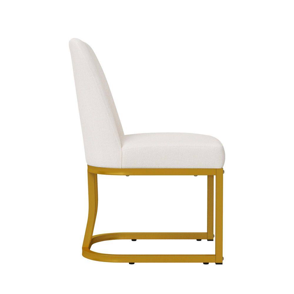 Side view of a beige upholstered dining chair with gold metal legs.