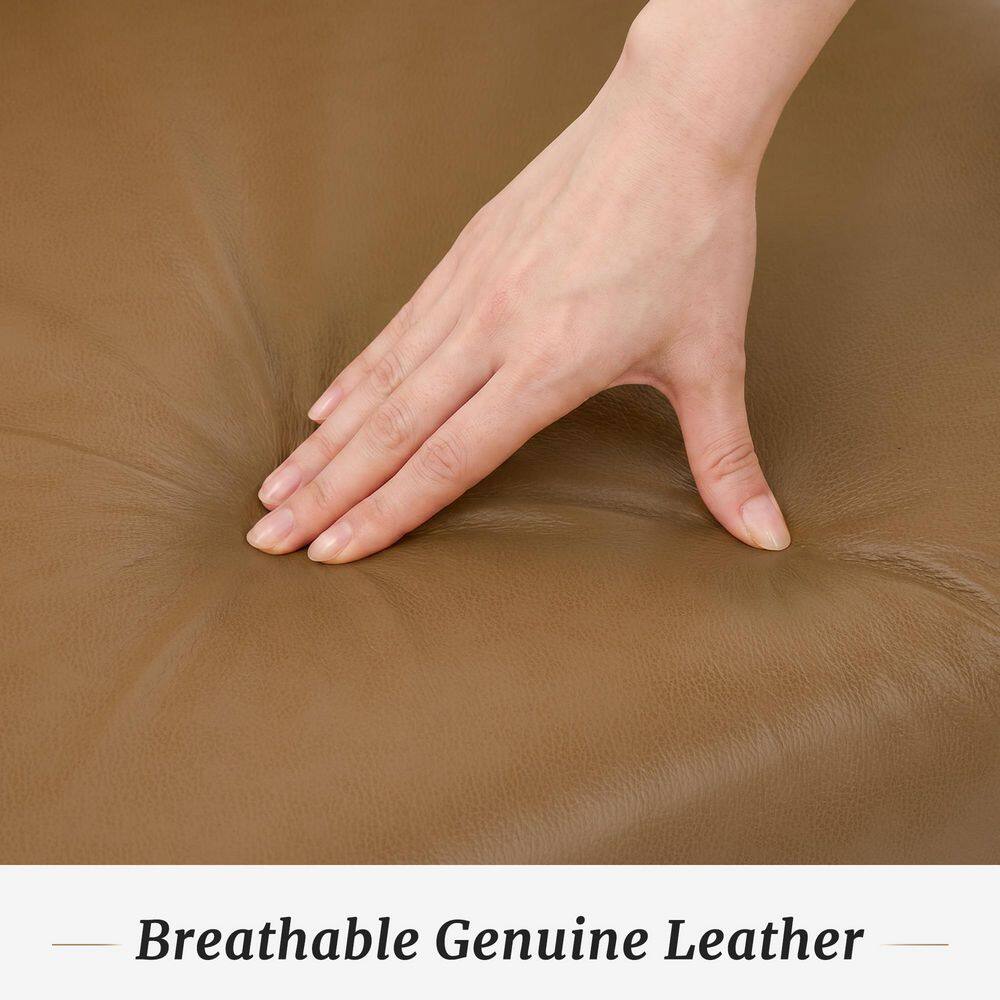 Close-up of a hand touching the breathable genuine leather material of the recliner chair.