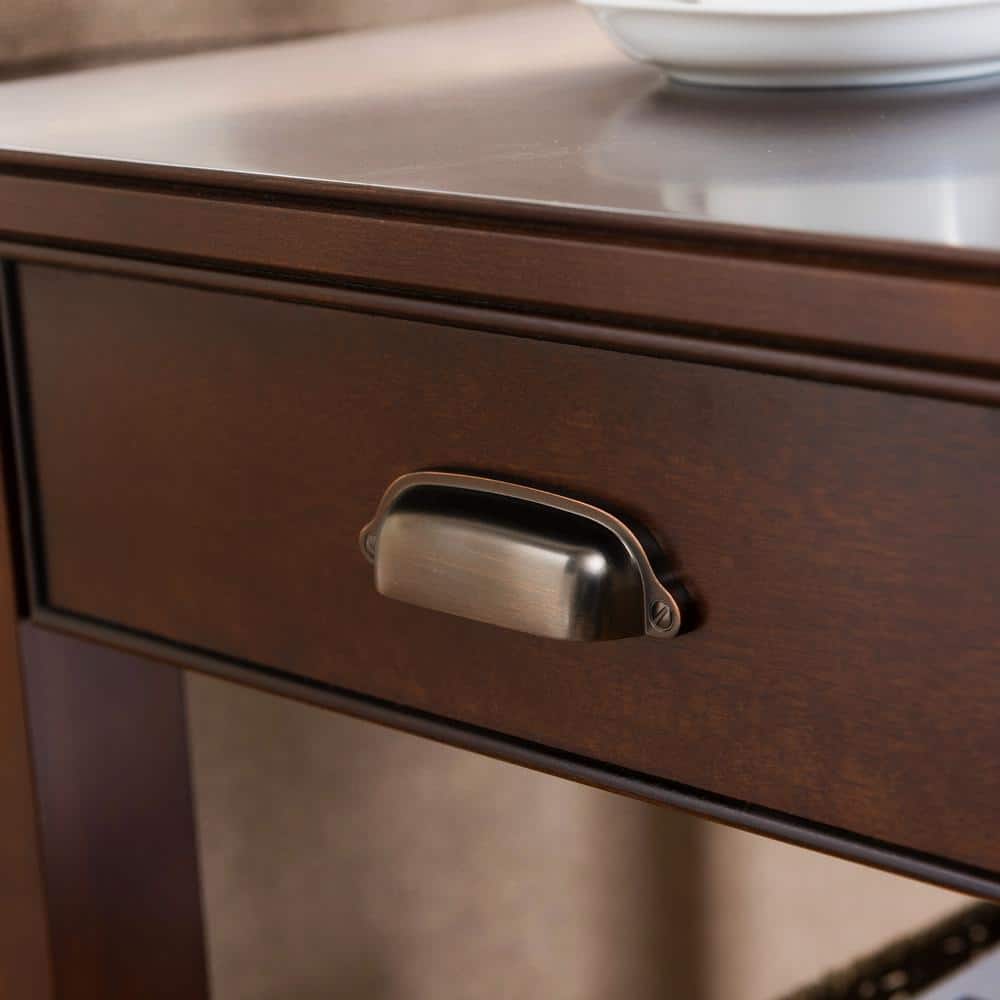 Close-up of the drawer and metallic handle of the chocolate cherry end table.