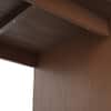 Close-up of wood grain texture on the desk paneling.