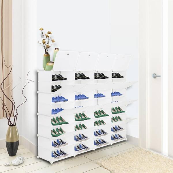 Floor to ceiling modular shoe shelves with decorative trim displaying bags  and shoes.