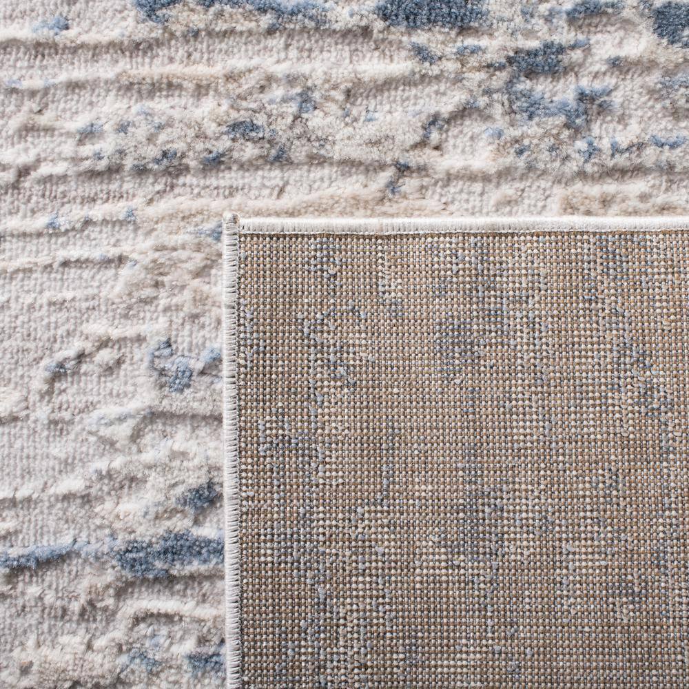 Ivory and Blue Abstract Synthetic Area Rug, 3' x 5'