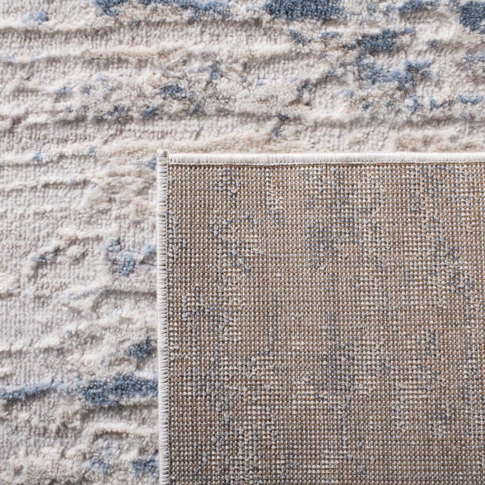 Ivory and Blue Abstract 6' x 9' Stain-Resistant Synthetic Rug