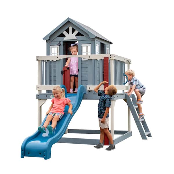 Backyard Discovery Beacon Heights Indoor Outdoor All Cedar Wooen Elevated Playhouse with Clubhouse, Ladder, Blue Slide, and Play Kitchen