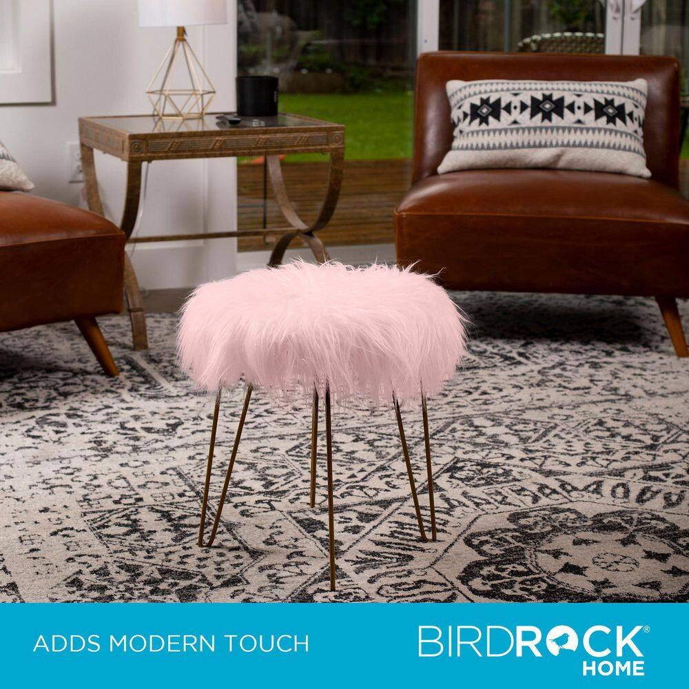 Pink faux fur ottoman stool in a living room with leather sofa.