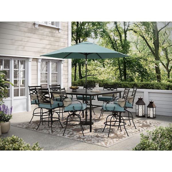Hanover Montclair 9-Piece Steel Outdoor Dining Set with Ocean Blue Cushions, 8 Swivel Chairs, 60 in. Table and Umbrella
