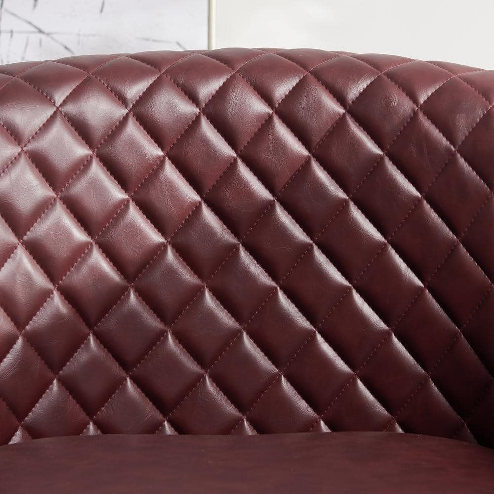 Close-up of diamond tufted red faux leather upholstery.