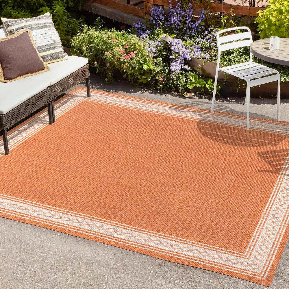 Lucia Cream and Orange Synthetic Indoor/Outdoor Area Rug