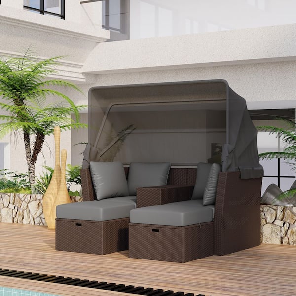 Brown Wicker Outdoor Day Bed with Gray Foldable Awning and Cushions