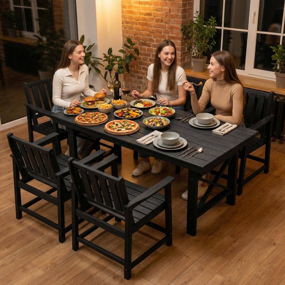 People dining outdoors using black patio chairs.