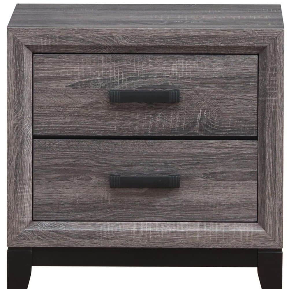 Close-up of the gray wood grain texture and black drawer pulls on a nightstand.