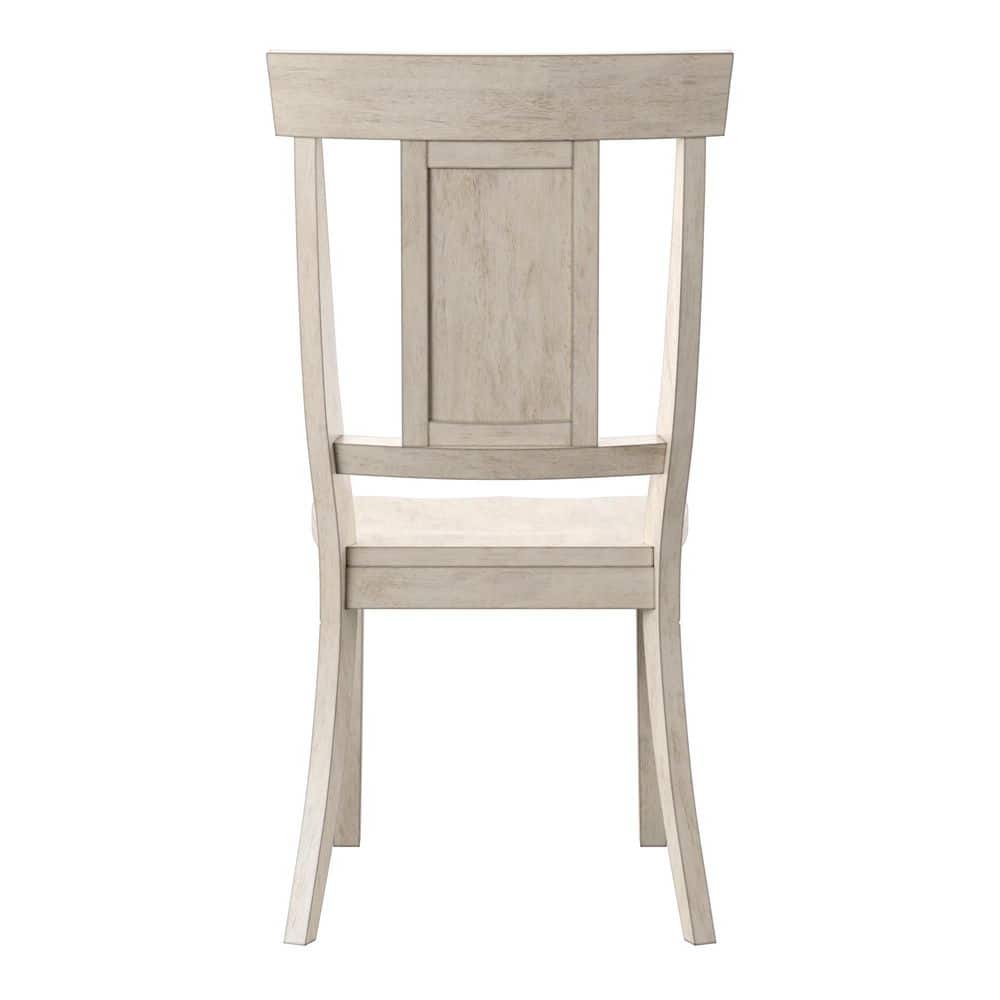 Back view of an antique white panel back wood dining chair.