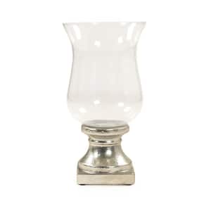Curved bell-shaped glass vase affixed to a distressed silver stand