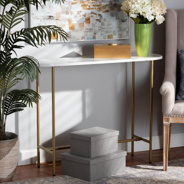 https://images.thdstatic.com/productImages/b2092923-b39e-4af6-bf1d-972a1e72ac9f/svn/white-and-gold-baxton-studio-console-tables-171-10995-hd-31_600.jpg