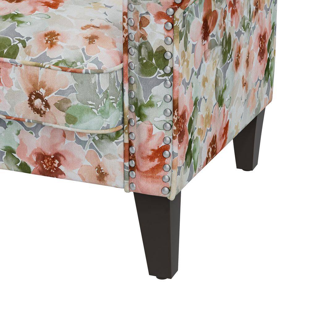 Close-up detail of floral fabric and nailhead trim on chair.