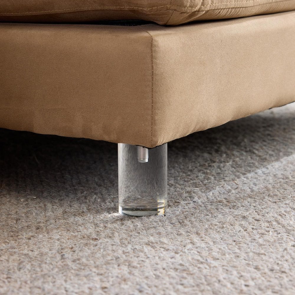 Close-up of the acrylic base and fabric edge of the sofa.