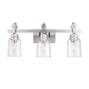 Knollwood 22-3/4 in. 3-Light Brushed Nickel Industrial Vanity Light with Vintage Accents and Clear Glass Shades