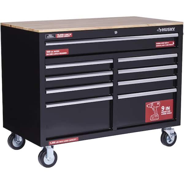 https://images.thdstatic.com/productImages/b2bb99c7-8088-41c5-a101-f71d6ab5df8e/svn/gloss-black-with-silver-trim-husky-mobile-workbenches-h46mwc9v2-40_600.jpg