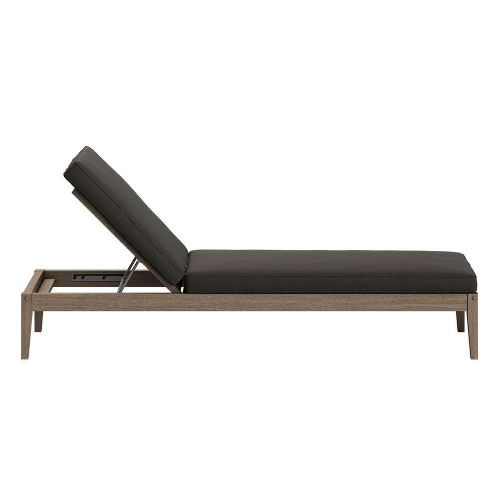 Outdoor chaise lounge with dark cushions and wood frame.