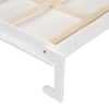 Close-up of white wood frame bed support structure.