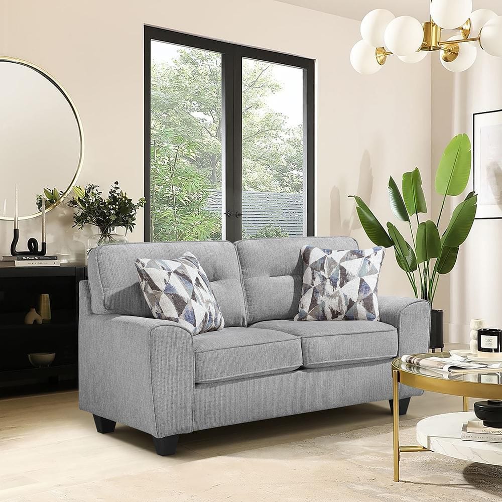 Gray chenille fabric loveseat with geometric accent pillows.