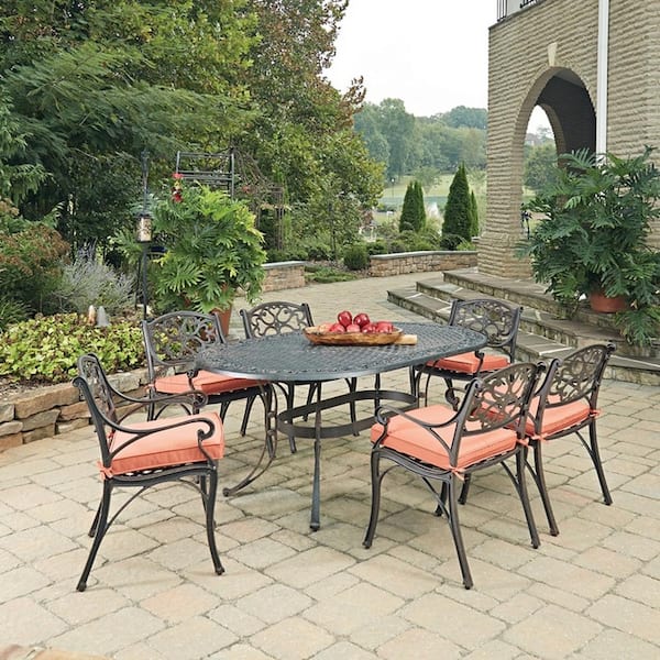 HOMESTYLES Sanibel Rust Bronze 7-Piece Cast Aluminum Oval Outdoor Dining Set with Orange Coral Cushions