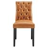 Front view of a tan vinyl dining chair with button-tufted back and black legs.