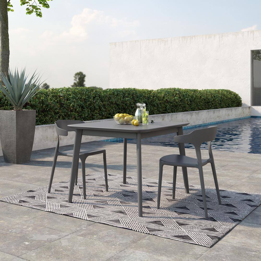 Charcoal grey dining chair and table set on a patio.