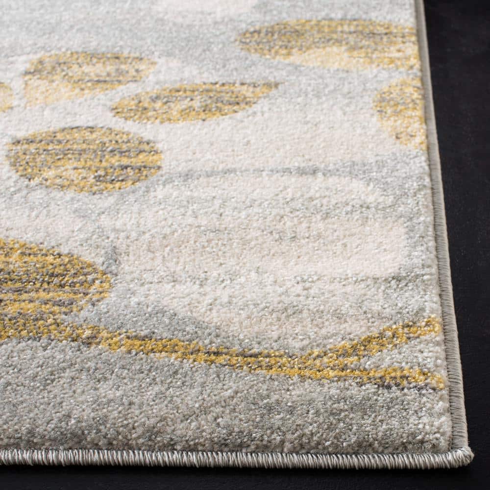 Rectangular 5' x 7' Grey and Gold Synthetic Area Rug