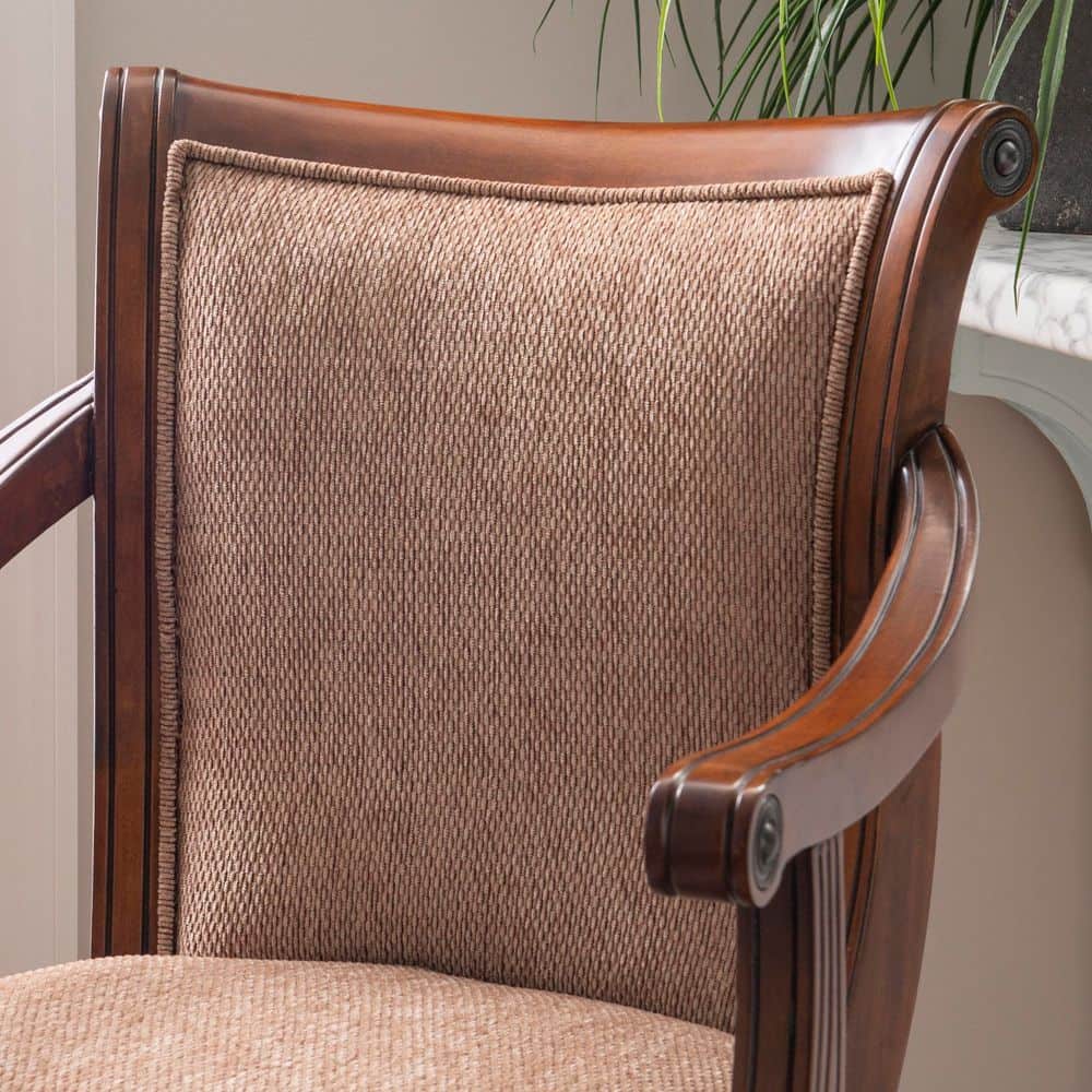 Close-up of the beige fabric upholstery and cherry wood armrest of the bar stool.