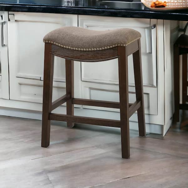 Counter Height Saddle Style Counter Stool With Grey Fabric And Nail Head Trim Counter Height Saddle Style Counter Stool With Grey Fabric And Nail Head Trim
