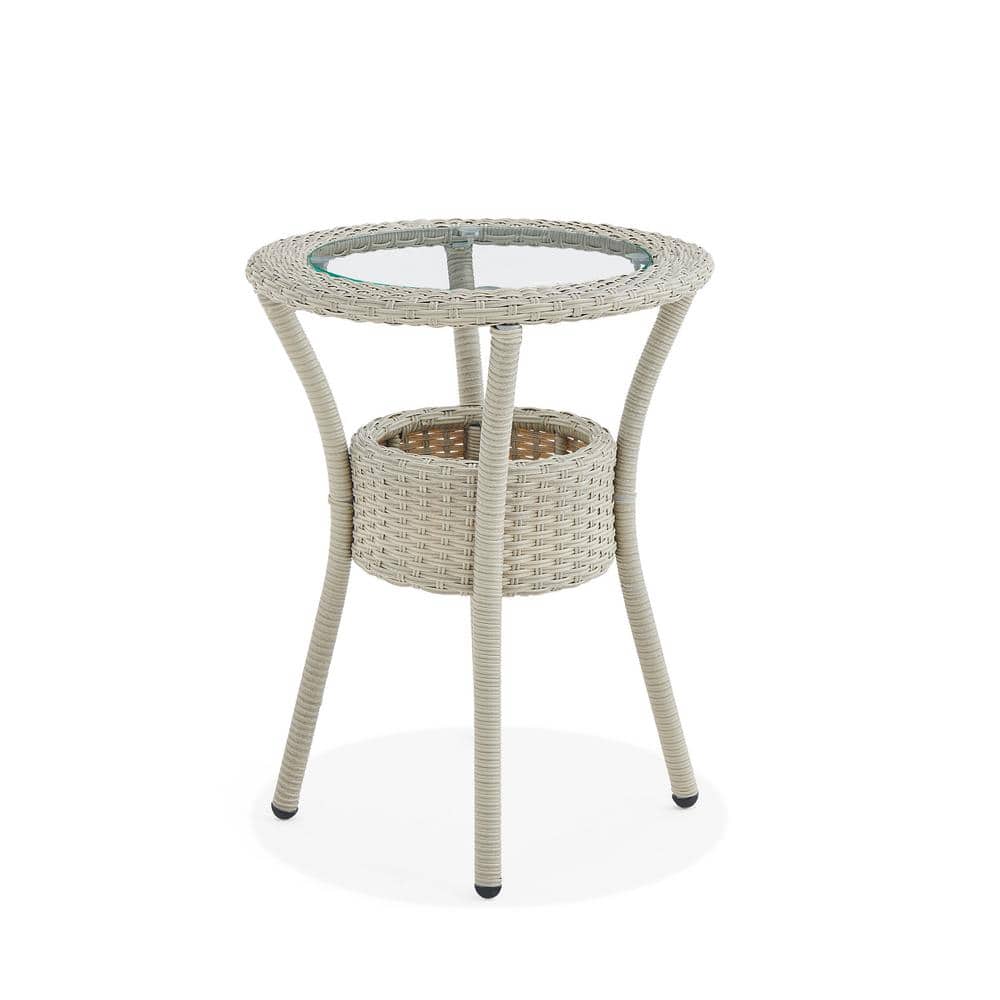 Beige wicker circular side table with a glass top and storage basket.
