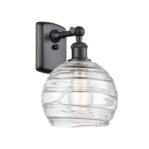Athens Deco Swirl 1-Light Matte Black Wall Sconce with Clear Deco Swirl Glass Shade