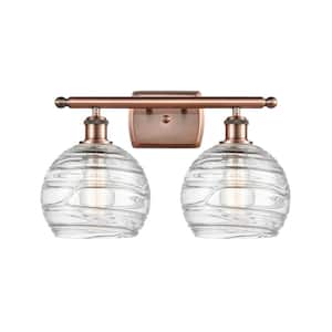 Athens Deco Swirl 18 in. 2-Light Antique Copper Vanity Light with Clear Deco Swirl Glass Shade