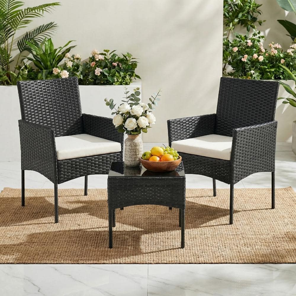 Black wicker patio bistro set with two chairs and a small glass table.