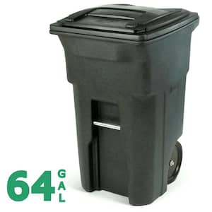 Green garbage container with open cover standing outdoors on dry