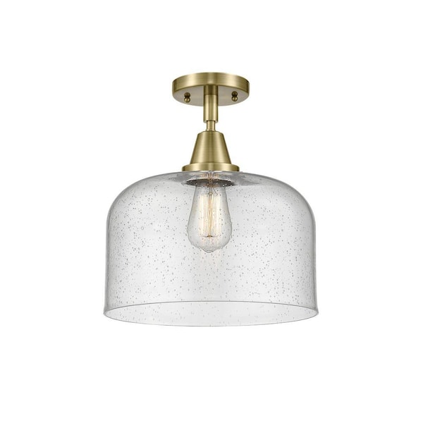 Bell 12 in. 1-Light Antique Brass Industrial Flush Mount with Seeded Glass Shade
