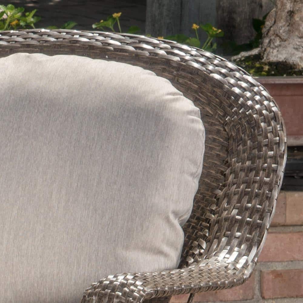 Close-up of the brown wicker weave and gray cushion of a lounge chair.