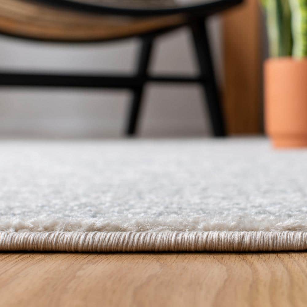 Ivory and Light Grey Geometric 6' x 9' Synthetic Area Rug