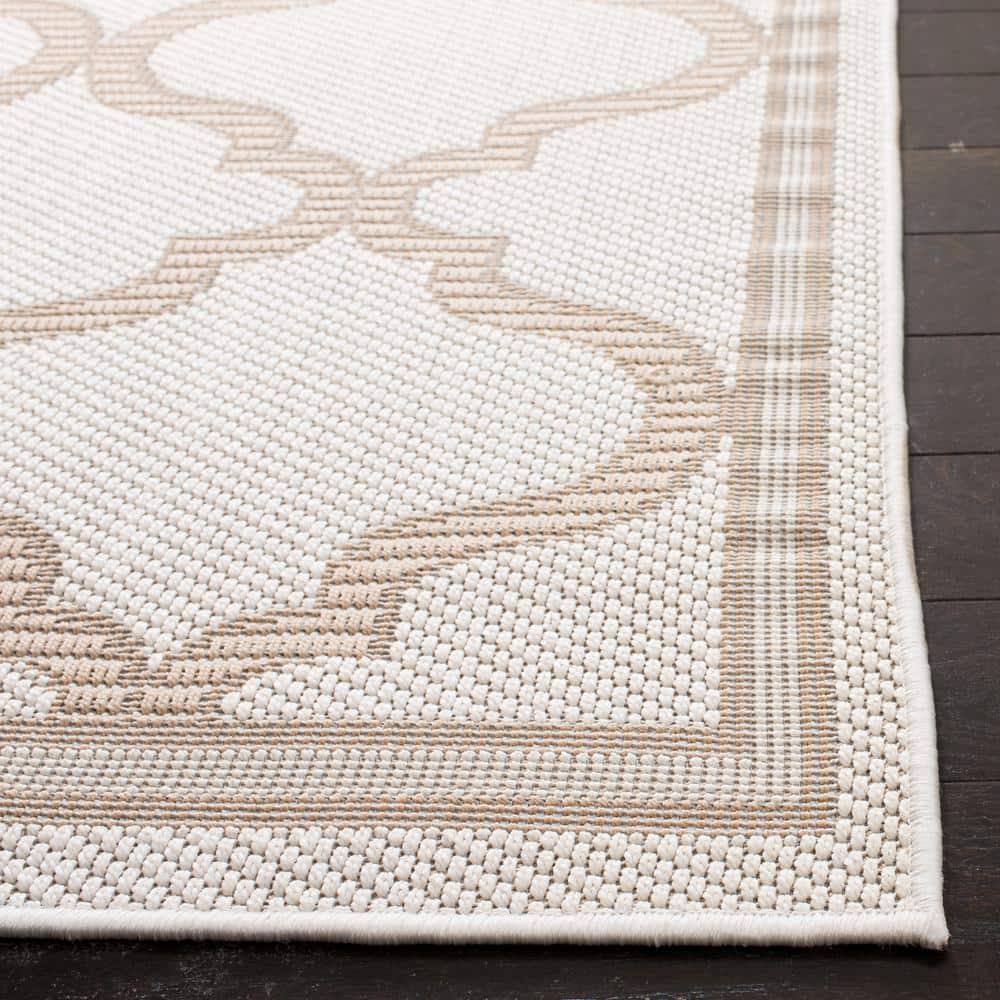 Ivory and Beige Geometric 8' x 10' Synthetic Area Rug
